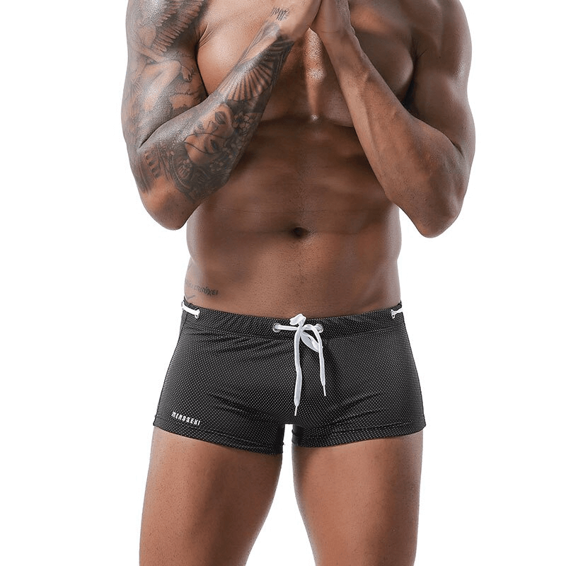 Man wearing black drawstring swimming boxers with tattoos showing. Male beachwear SF0810.